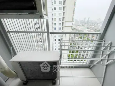 Modern balcony with city view and air conditioning unit in high-rise building.