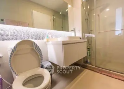 Modern bathroom with sleek fixtures and glass shower enclosure