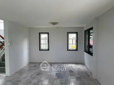 Spacious empty room with marble flooring and large windows