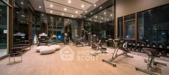 Luxurious modern gym with state-of-the-art equipment and floor-to-ceiling windows.