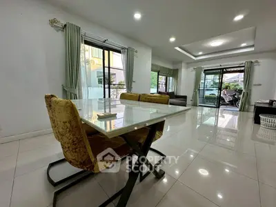 Spacious modern living room with elegant dining area and large windows