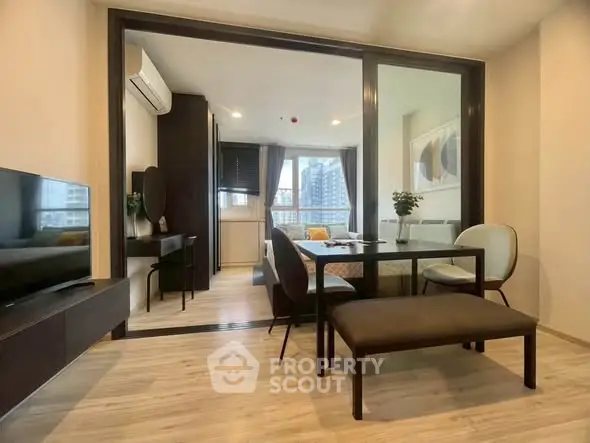 Modern living room with stylish furniture and large windows offering city views.