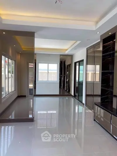 Spacious modern living room with glossy floors and large windows