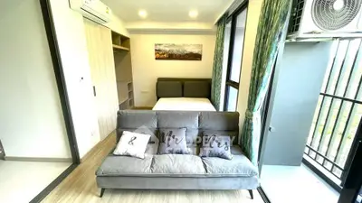 Modern studio apartment with stylish decor and balcony access.