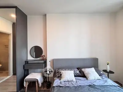 Modern bedroom with stylish decor and cozy ambiance, featuring a comfortable bed and elegant furnishings.