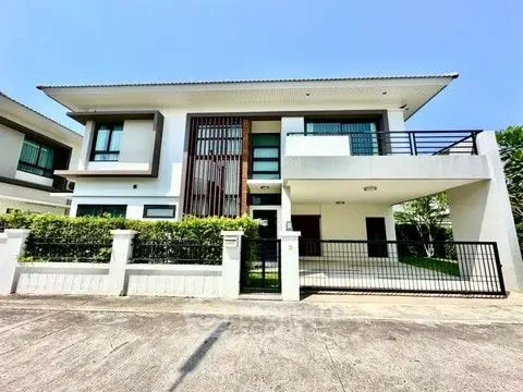 Modern two-story house with sleek design and spacious balcony in a serene neighborhood.