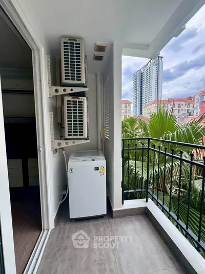 Charming balcony with city view and air conditioning units, perfect for urban living.