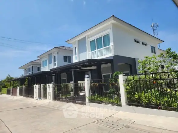 Modern two-story house with spacious driveway and lush garden
