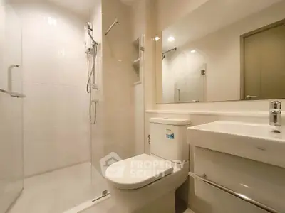 Modern bathroom with sleek shower and elegant fixtures in a contemporary apartment.