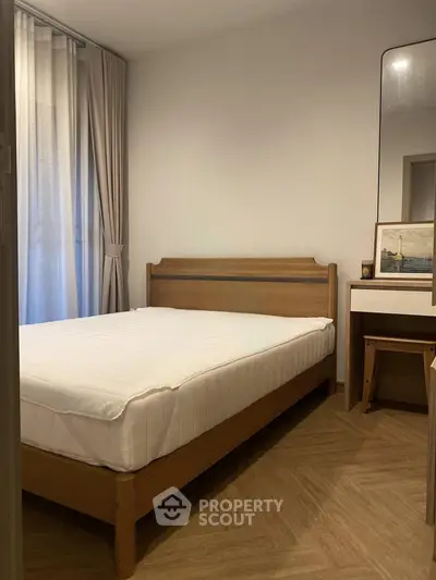 Cozy bedroom with wooden bed frame and elegant decor, perfect for restful nights.