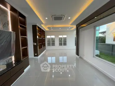 Luxurious modern living room with recessed lighting and large windows