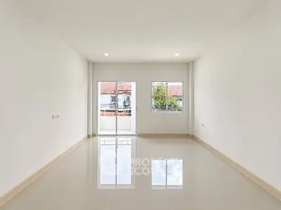 Spacious empty room with large windows and glossy tiled floor, perfect for customization.