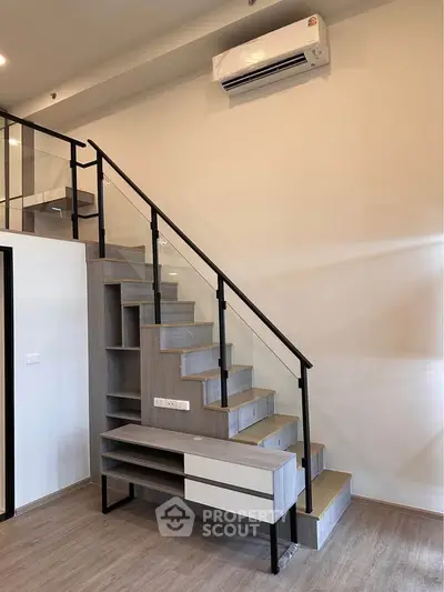 Modern staircase with built-in storage and sleek design in a contemporary home interior.