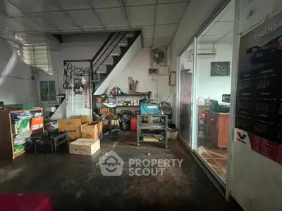 Industrial-style storage room with staircase and sliding glass door