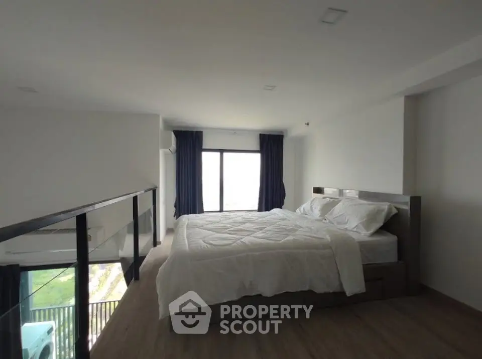 Spacious modern bedroom with large window and elegant decor