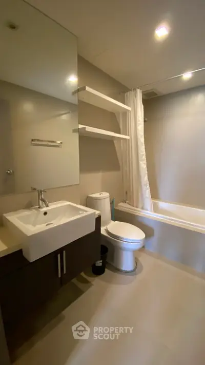 Modern bathroom with sleek fixtures and bathtub in contemporary apartment