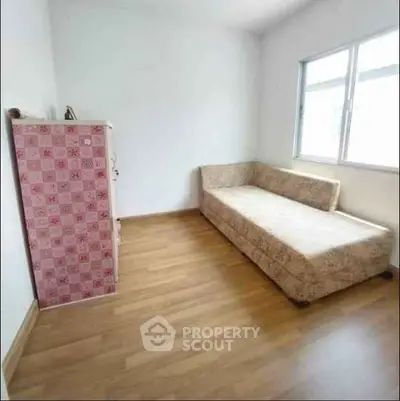 Cozy minimalist room with wooden flooring and natural light