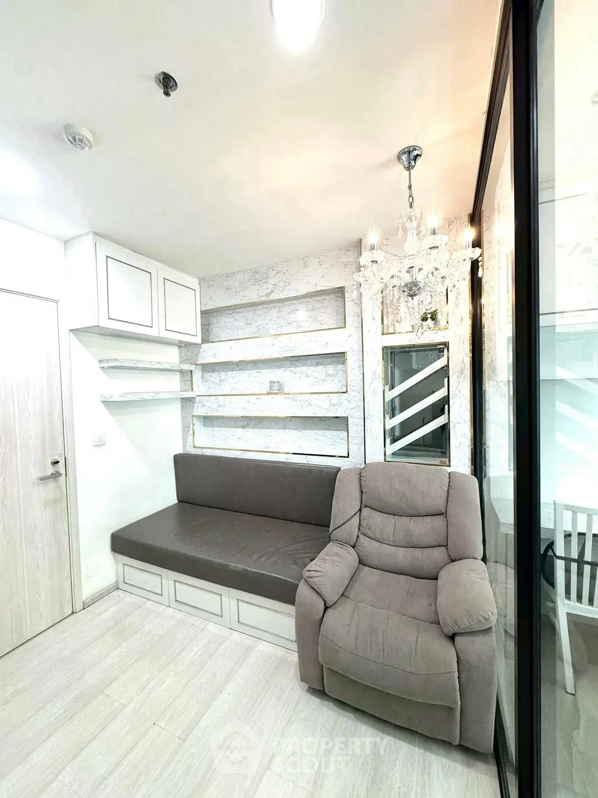 Cozy living room with elegant chandelier and modern built-in seating.