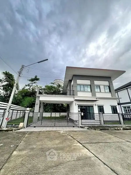 Modern two-story house with sleek design and spacious driveway