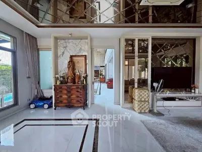 Luxurious living room with elegant decor and large windows offering natural light.