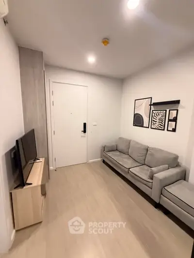 Modern living room with stylish decor and cozy seating in a contemporary apartment.