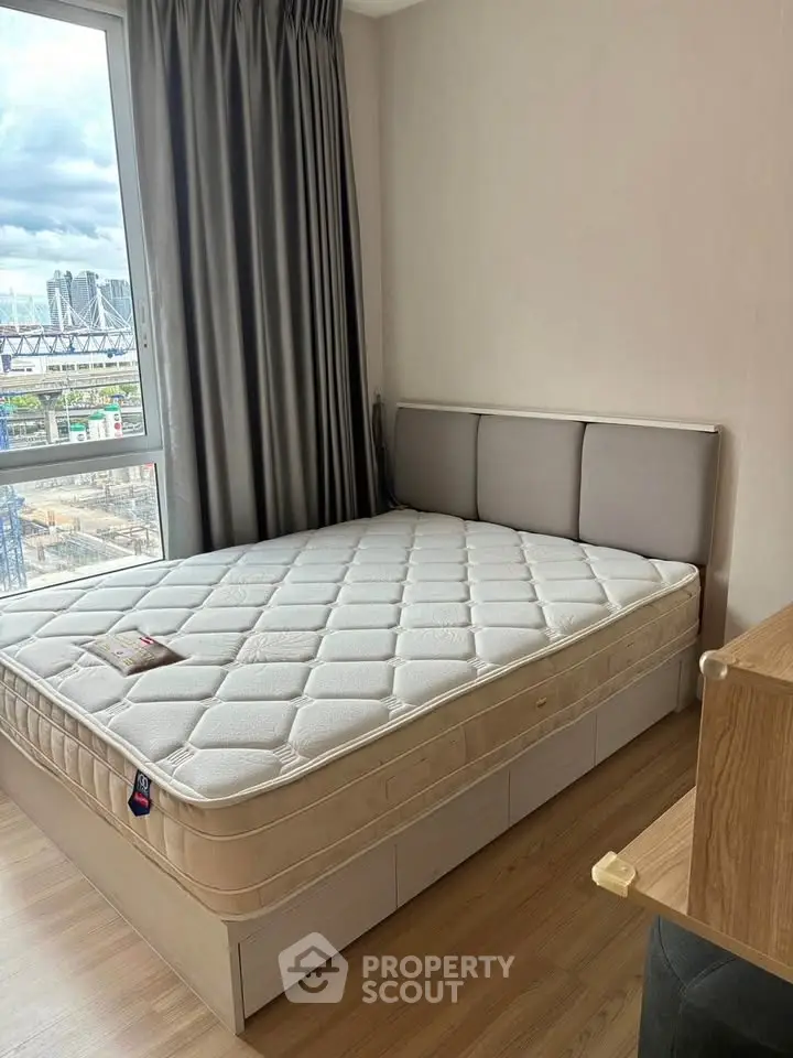 Modern bedroom with large window and stylish bed in urban apartment