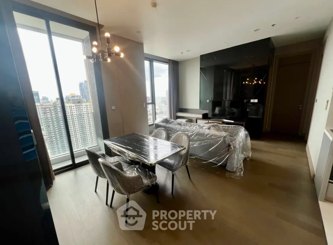 Modern living room with dining area and city view in luxury apartment