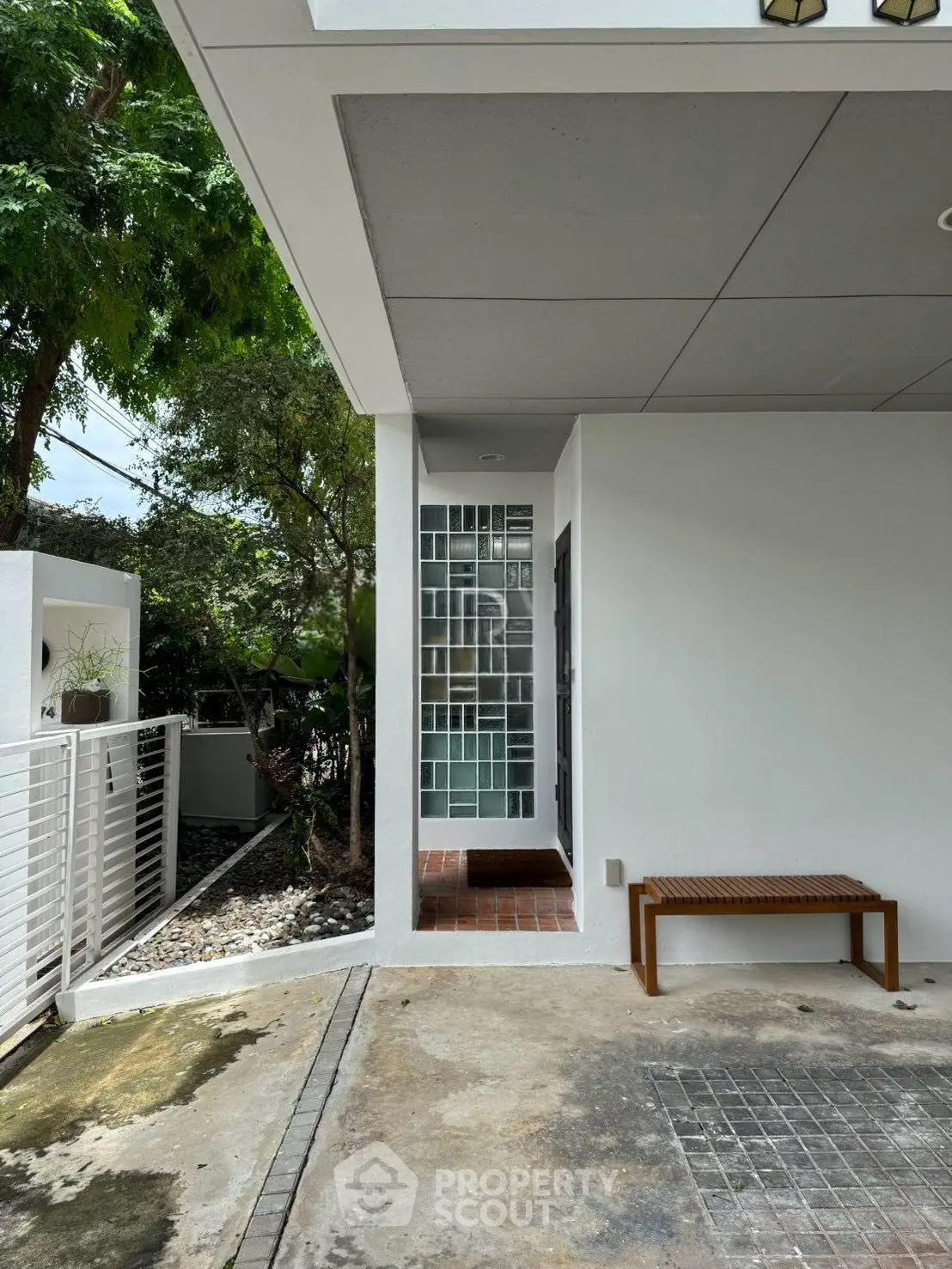 Modern minimalist home exterior with sleek design and natural surroundings
