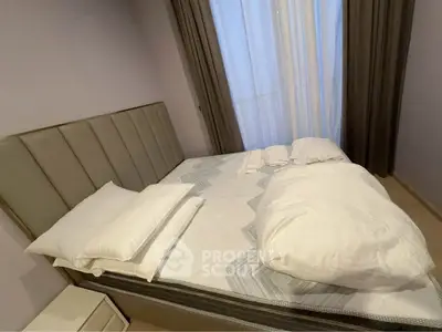 Cozy bedroom with modern bed and soft lighting, perfect for relaxation.
