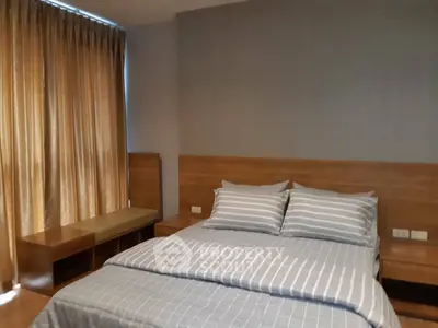 Cozy bedroom with modern decor and striped bedding