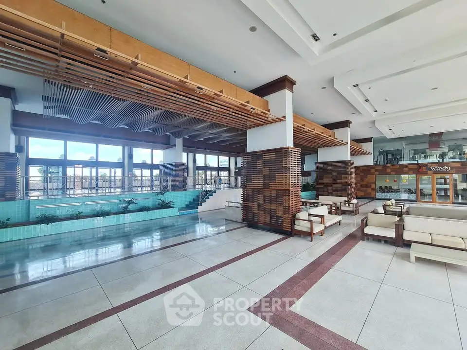 Spacious modern lobby with stylish seating and large windows offering natural light.
