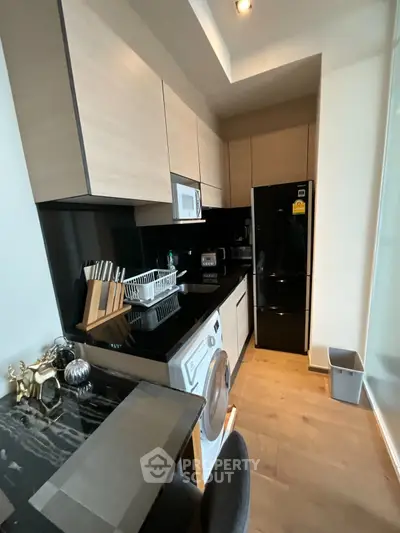 Modern kitchen with sleek black countertops and built-in appliances