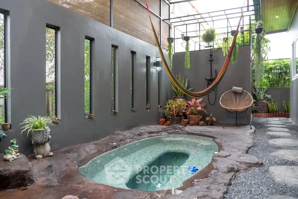 Charming outdoor space with unique stone pool and hammock, perfect for relaxation and entertaining.