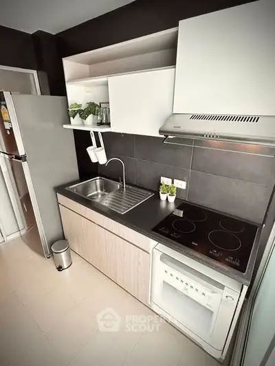 Modern kitchen with sleek appliances and open shelving in a stylish apartment.