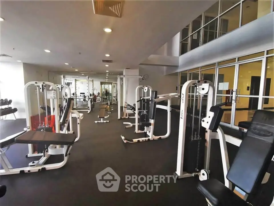Spacious modern gym with state-of-the-art fitness equipment in a luxury residential building.