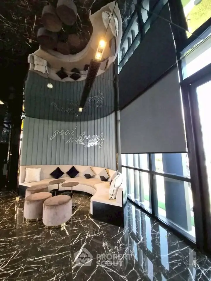 Luxurious modern living room with elegant marble flooring and stylish seating area.