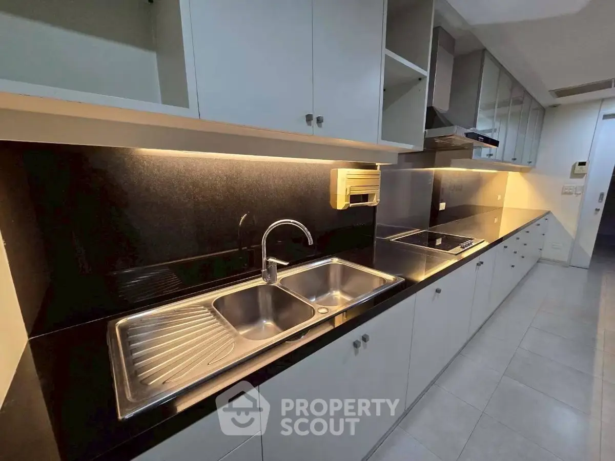 Modern kitchen with sleek cabinetry and stainless steel sink