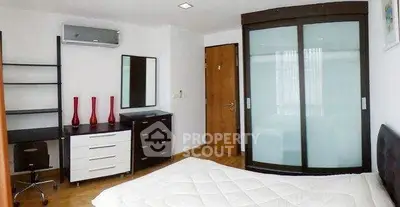 Modern bedroom with sleek furniture and ample storage space