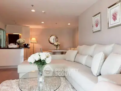 Elegant living room with plush sofa and modern decor in open layout apartment.