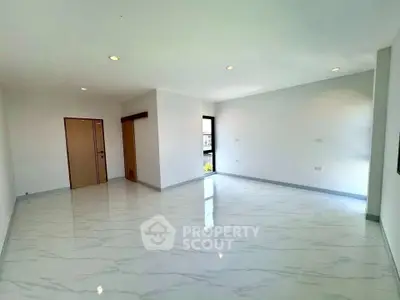 Spacious modern living room with marble flooring and ample natural light