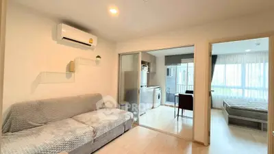 Modern apartment interior with cozy living room, open kitchen, and bright bedroom.
