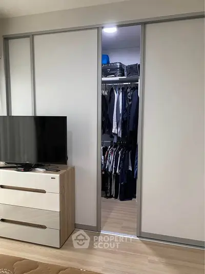 Spacious bedroom with sliding closet doors and modern dresser