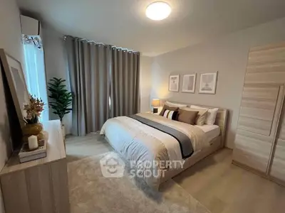 Elegant bedroom with modern decor and cozy ambiance, featuring a large bed and stylish furnishings.