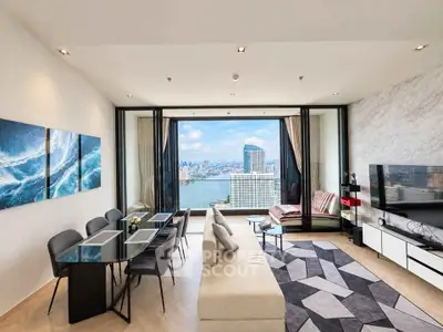 Luxurious living room with stunning city and river view, modern decor, and spacious layout.