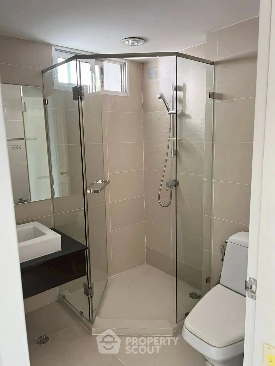 Modern bathroom with glass shower enclosure and sleek fixtures