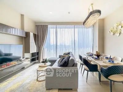 Luxurious living room with elegant decor and large windows offering natural light.