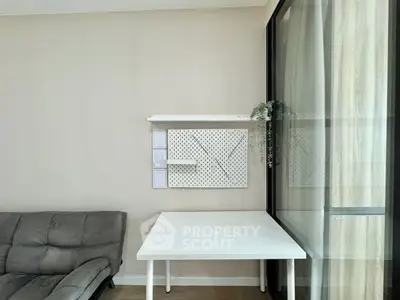 Modern minimalist living area with sleek furniture and wall-mounted storage solutions.