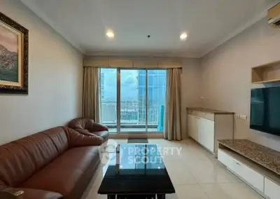 Spacious living room with leather sofa and city view balcony in modern apartment.