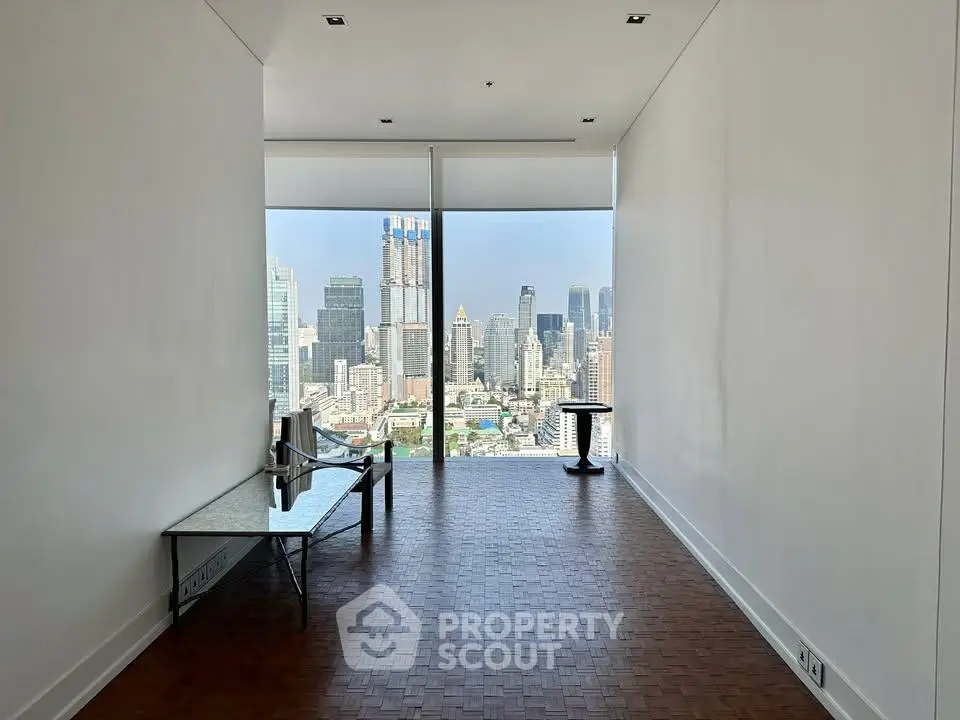 Spacious modern room with stunning city skyline view through large windows, perfect for urban living.