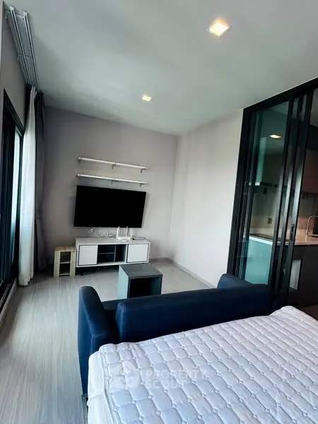Modern studio apartment with sleek design and large windows for natural light.